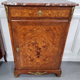 Elegant French transitional style Walnut & Kingwood Salon cabinet. It has beautiful marquetry inlay, a marble top and decorative ormolu mounts. Sourced From France and is in good original detailed condition.
