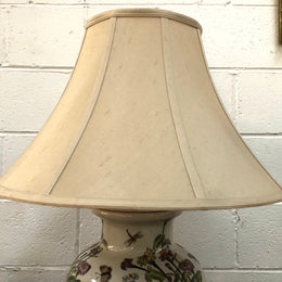 Contemporary ceramic lamp base decorated with daises & butterflies on a wooden base with shade.