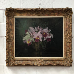 Signed French oil on canvas painting of "Orchids In Basket" In a beautiful ornate gilt frame. In good original detailed condition.