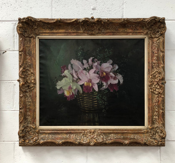 Signed French oil on canvas painting of "Orchids In Basket" In a beautiful ornate gilt frame. In good original detailed condition.
