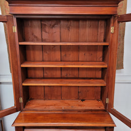 Mid 19th Century Australian Cedar and Flame Cedar tall bookcase. The top has two glass doors that open up to three adjustable shelves followed by a drawer in the middle and finishes with two beautiful wooden doors that open up to a fixed shelf. In good original detailed condition and has been sourced locally.