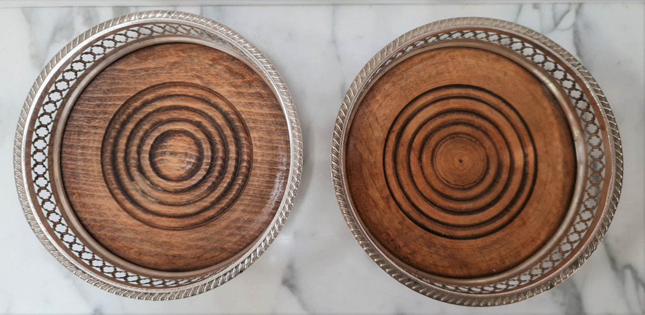 Gorgeous pair of vintage silver plate wine coasters with stunning turned wooden base. Not marked. In great original condition.