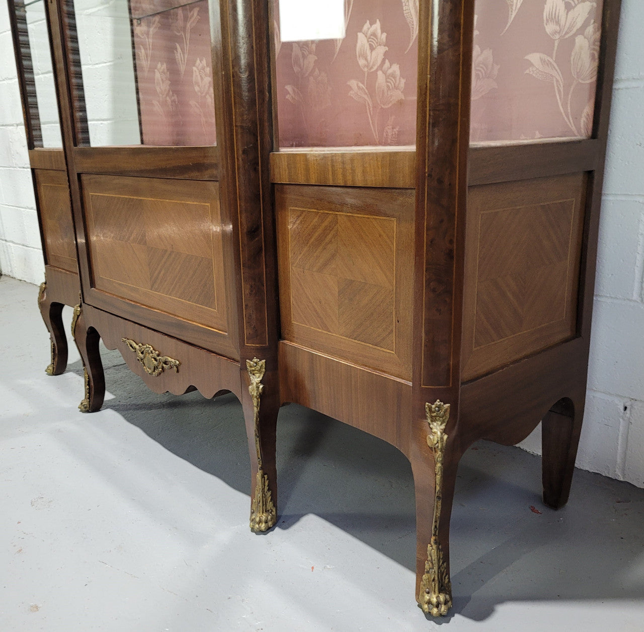 Beautiful French Louis XV style large walnut display cabinet with lovely ormolu mounts . There are two glass shelves and has its original dusky pink fabric in good condition.