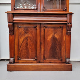 Mid 19th Century Australian Cedar and Flame Cedar tall bookcase. The top has two glass doors that open up to three adjustable shelves followed by a drawer in the middle and finishes with two beautiful wooden doors that open up to a fixed shelf. In good original detailed condition and has been sourced locally.