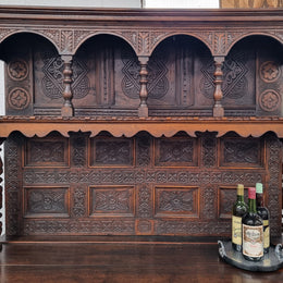 Impressively carved 18th Century English Oak kitchen dresser in 17th Century Jacobean style. It is in good original detailed condition and has been sourced from France.