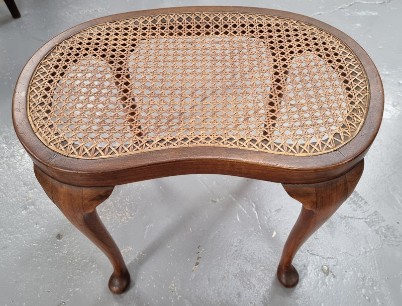 Hard to find English stool with cane top. Kidney shaped with beautiful cabriole legs and is in good original condition.