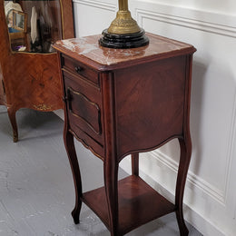 French Rosewood inset marble top single bedside cabinet with one drawer and one cupboard on elegant legs. Would also make a practical and stunning table lamp. It is in good original detailed condition.
