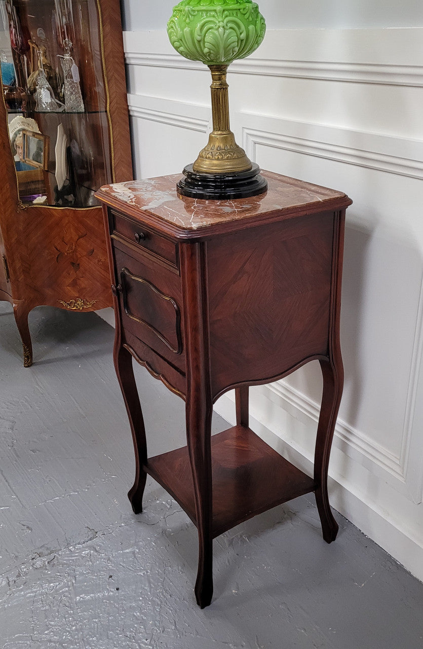 French Rosewood inset marble top single bedside cabinet with one drawer and one cupboard on elegant legs. Would also make a practical and stunning table lamp. It is in good original detailed condition.