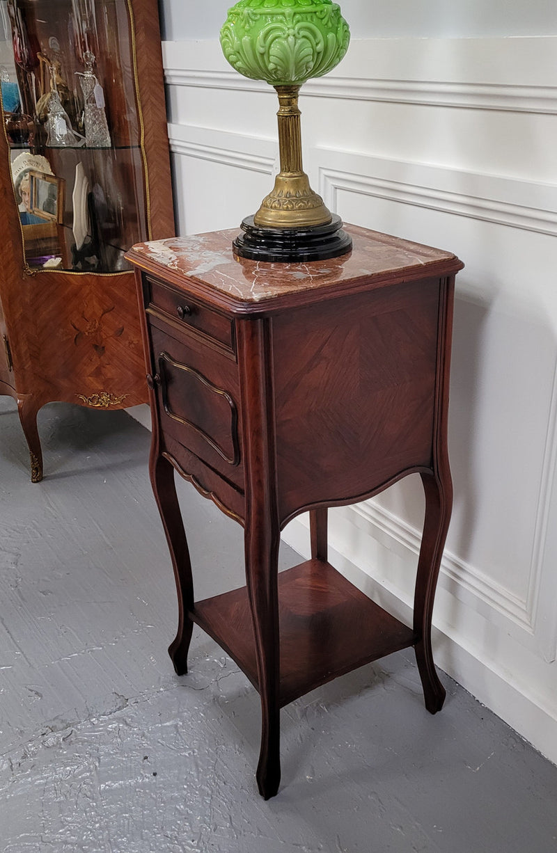 French Rosewood inset marble top single bedside cabinet with one drawer and one cupboard on elegant legs. Would also make a practical and stunning table lamp. It is in good original detailed condition.