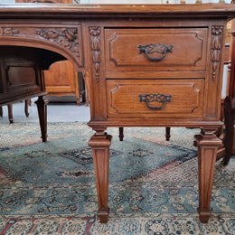 Substantial French Louis XVI style Oak partners desk. It has a beautiful leather top, two drawers on either side and decorative carvings throughout. Sourced from France and in good original detailed condition.