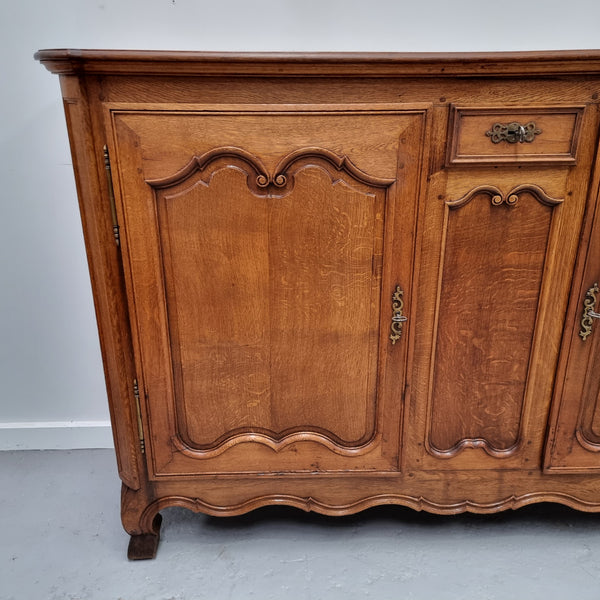 Amazing French Oak early 19th Century two door sideboard with one drawer and two fixed shelves. Sourced from France and in good original detailed condition.