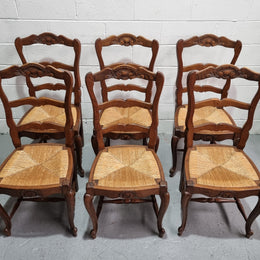 Lovely set of six French oak rush seated provincial dining chairs. They have been sourced from France and are in good detailed condition.