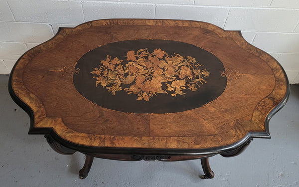 French Napoleon III style centre table. Made from Rosewood and figured Walnut and is beautifully inlaid with an ebonized edge.  It has an attractive carved undercarriage and single drawer. In good original detailed condition.
