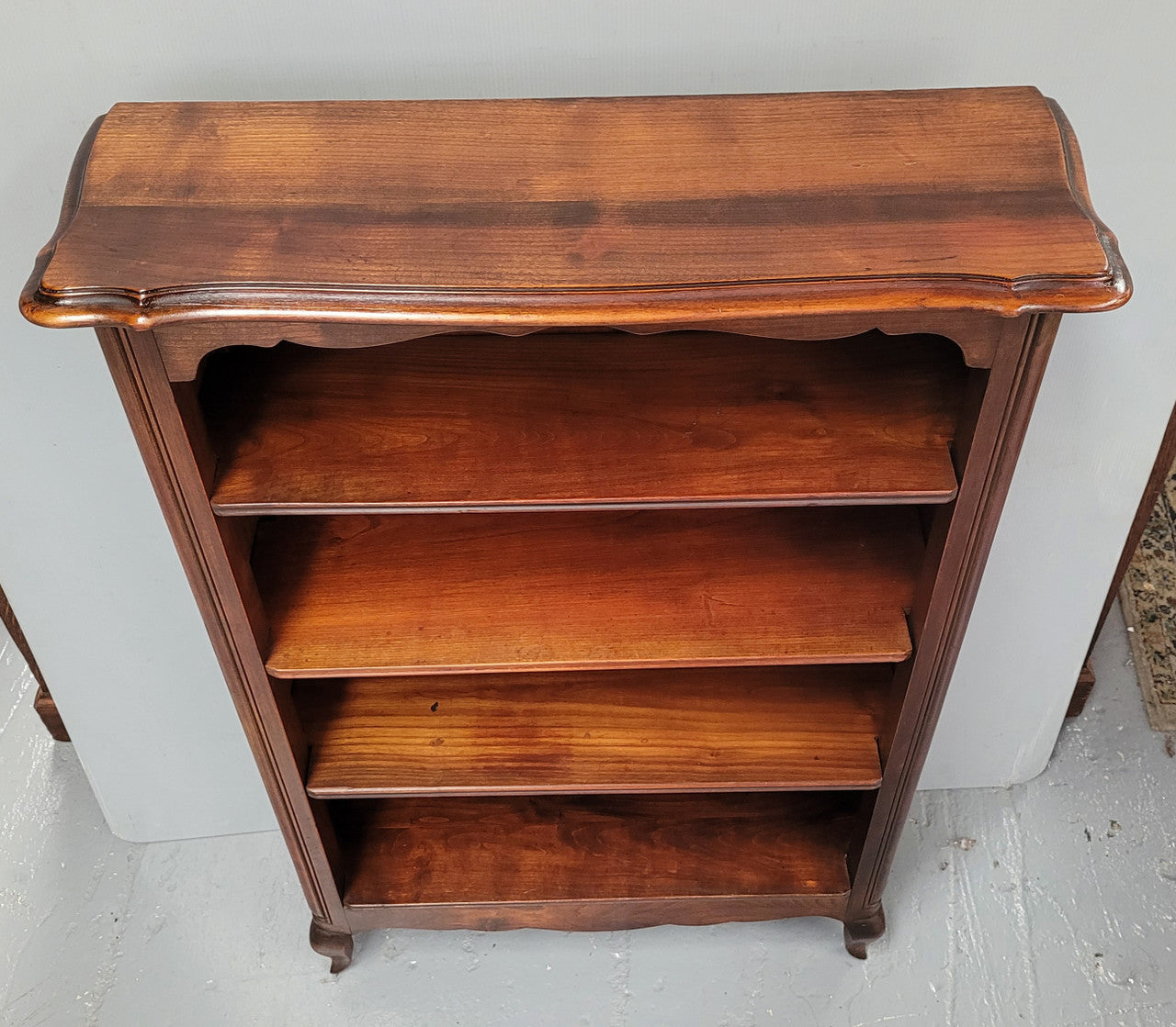 Compact French Louis XV Style Walnut four shelf open bookcase. In good original detailed condition.