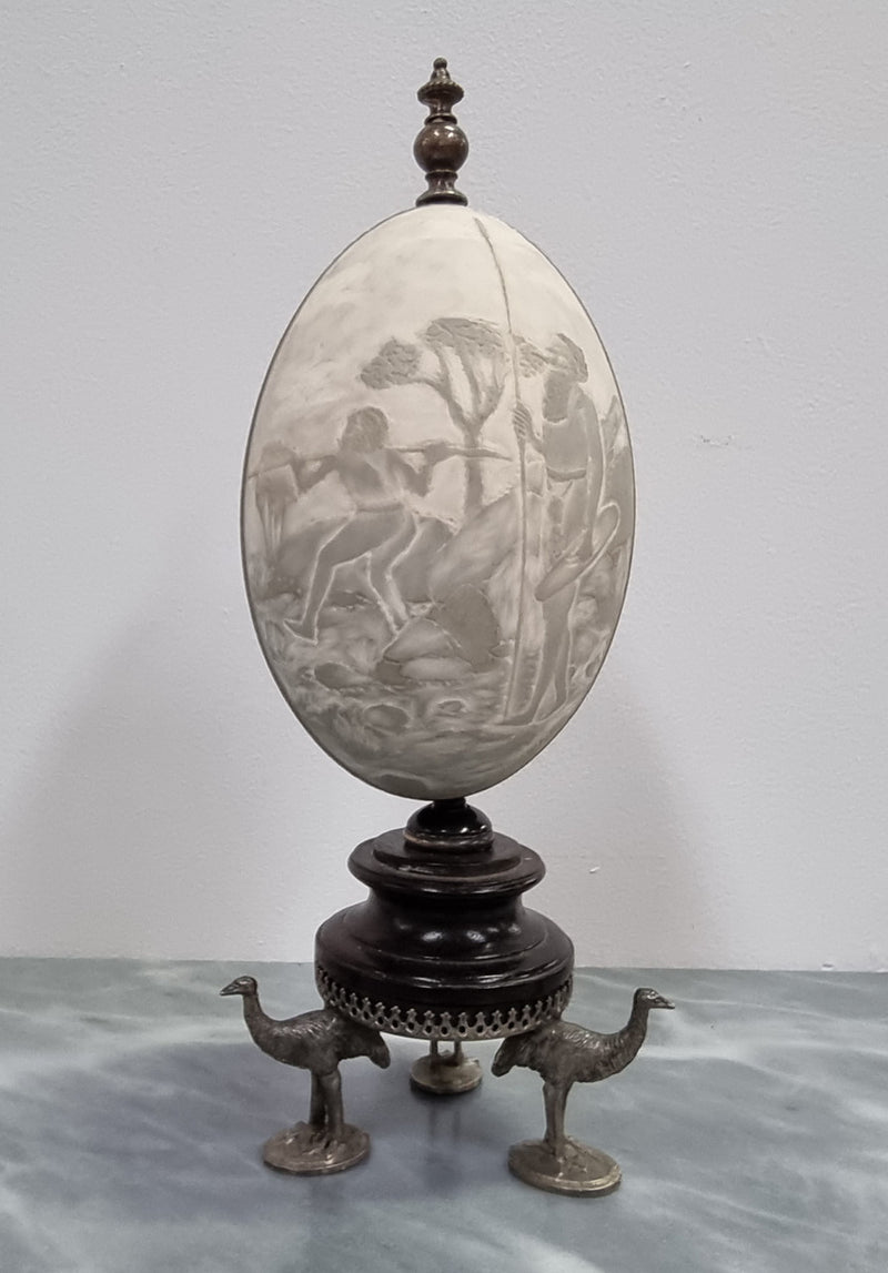 Superbly carved Emu egg on a emu metal and ebony base. It depicts an Aboriginal hunting scene and dreaming's. It is in good original condition, please view photos as they help form part of the description.