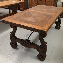 French Oak Renaissance style extension table with a lovely parquetry top and decorative carved and iron base in good original detailed condition.