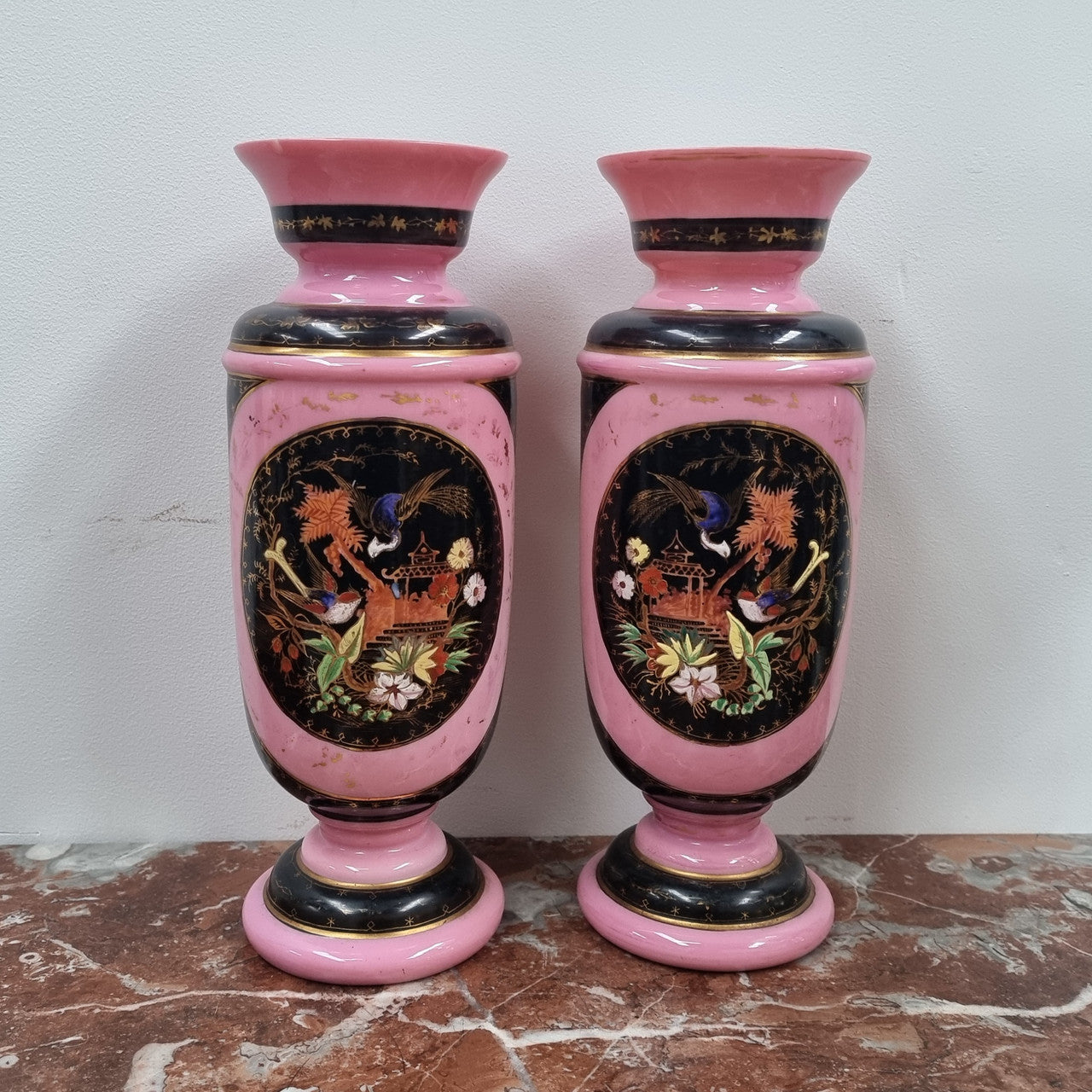 Late Victorian pink and hand painted, enameled pair of vases with some ware to enameling. It is in good original condition.