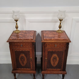 Pair of French Art Deco Oak and rouge inset marble top bedside cabinets. They have one drawer and one cupboard with elegant carving on the door. They have been sourced from France and are in good original detailed condition.