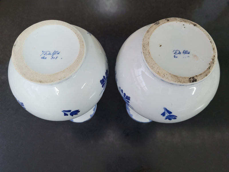 Pair of Victorian delft blue hand painted vases. Stamped underneath and one featuring a ship scene and the other a windmill scene. Please note the windmill vase does have a hairline crack at the top otherwise in good condition, please view photos as they help form part of the description.