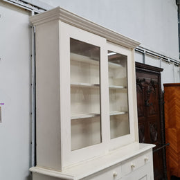 Australian painted two door kitchen hutch display and buffet cabinet. The top section has hooks and shelves. The bottom has two drawers along with cupboard space for added storage. In good original condition.
