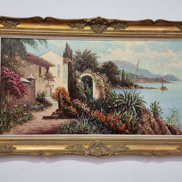 Sourced in France a colorful signed oil on canvas " Mediterranean coastal scene" in a decorative gilt frame. It is in good original detailed condition.