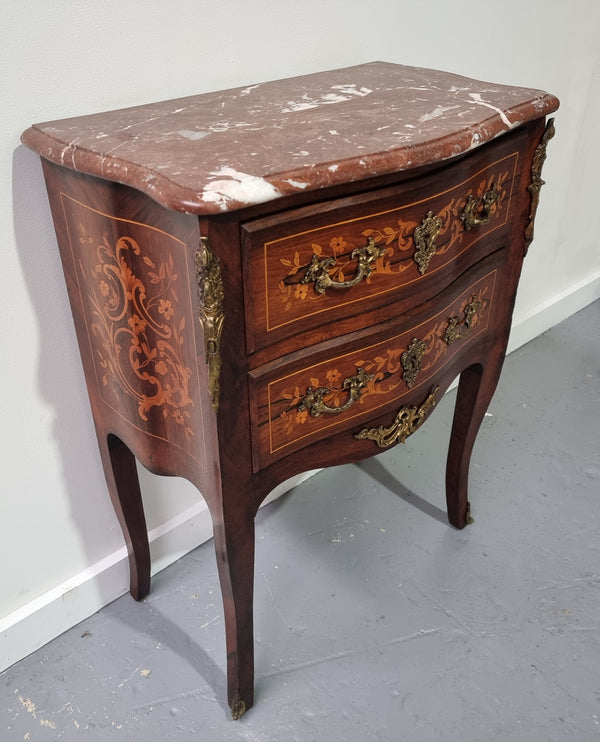 A stunning French petite two drawer inlaid Rosewood commode. In good original detailed condition.
