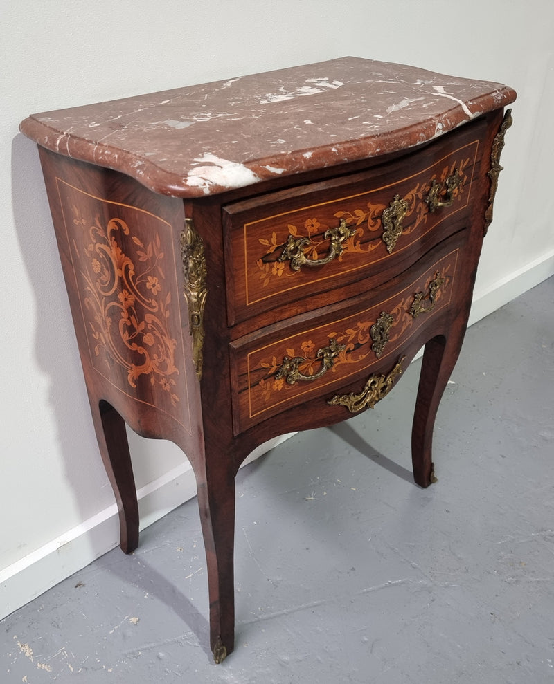 A stunning French petite two drawer inlaid Rosewood commode. In good original detailed condition.