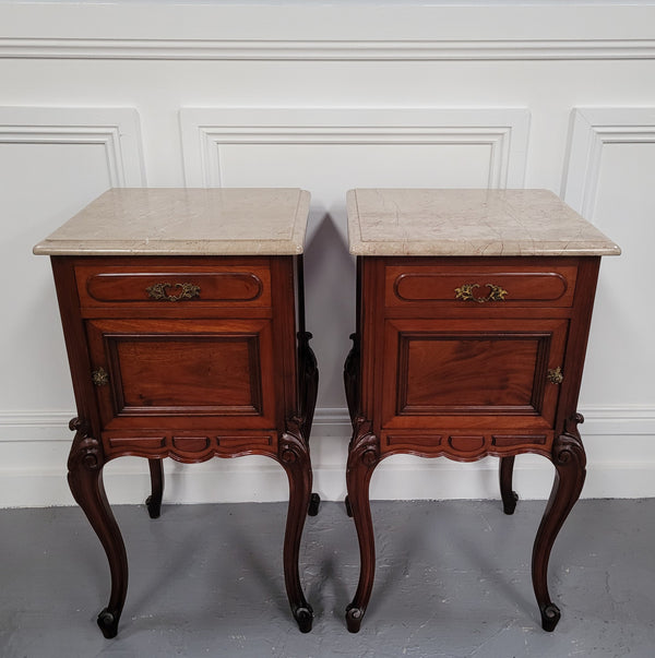 Pair of French Antiloopque Louis XV style Walnut and marble top bedsides. They have lovely carvings along with a drawer and cupboard space. They are in good original detailed condition and have been sourced from France
