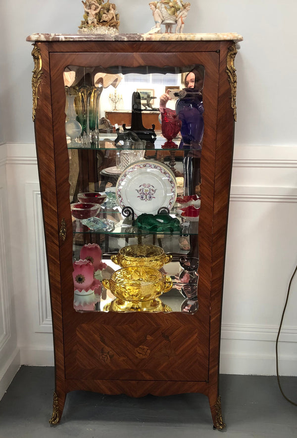 A Louis XV style Kingwood vitrine with marble top. It has beautifully floral inlay with ormolu mounts.