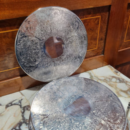 Five Strachan and two Rodd silver plate table coasters in a silver plate stand. In good original detailed condition.