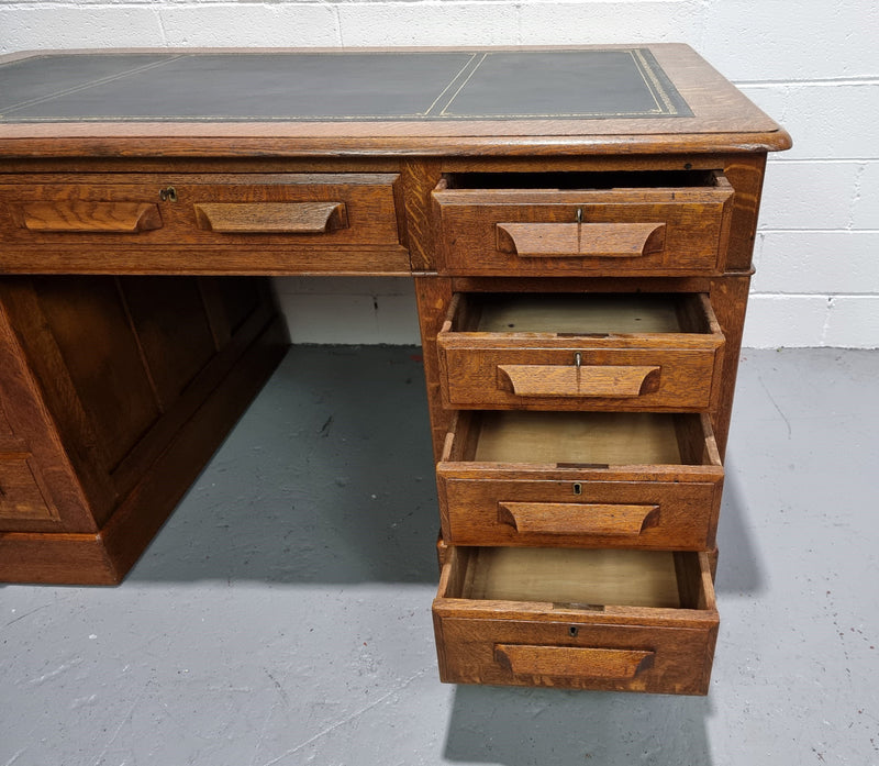 Amazing American Oak full partners leather top desk. Plenty of storage space with nine drawers on one side and two cupboards of the oppsite side. It is in good restored condition and has a new leather and gold tooled inset top.