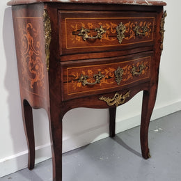 A stunning French petite two drawer inlaid Rosewood commode. In good original detailed condition.