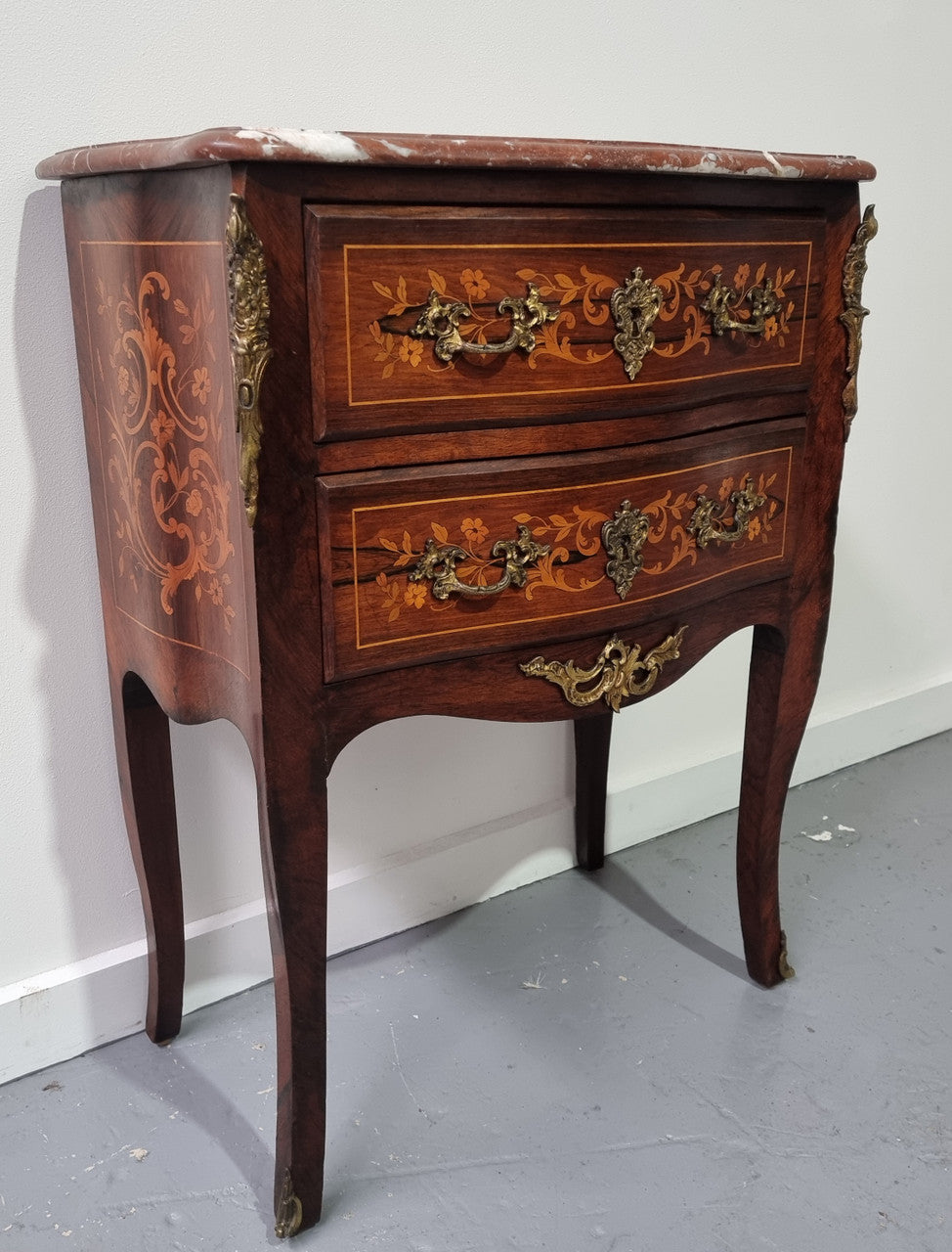 A stunning French petite two drawer inlaid Rosewood commode. In good original detailed condition.