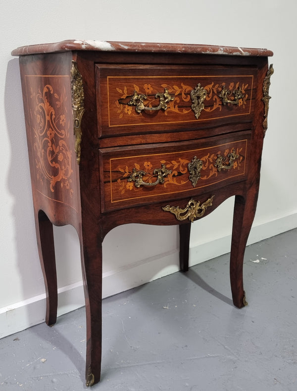 A stunning French petite two drawer inlaid Rosewood commode. In good original detailed condition.