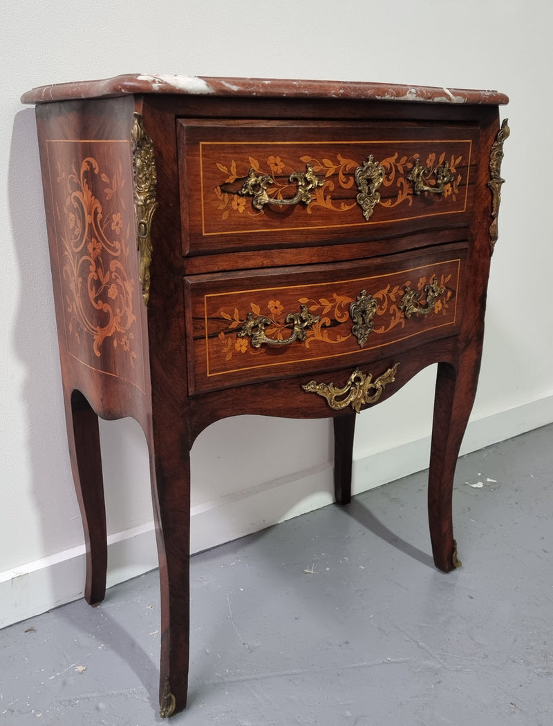 A stunning French petite two drawer inlaid Rosewood commode. In good original detailed condition.