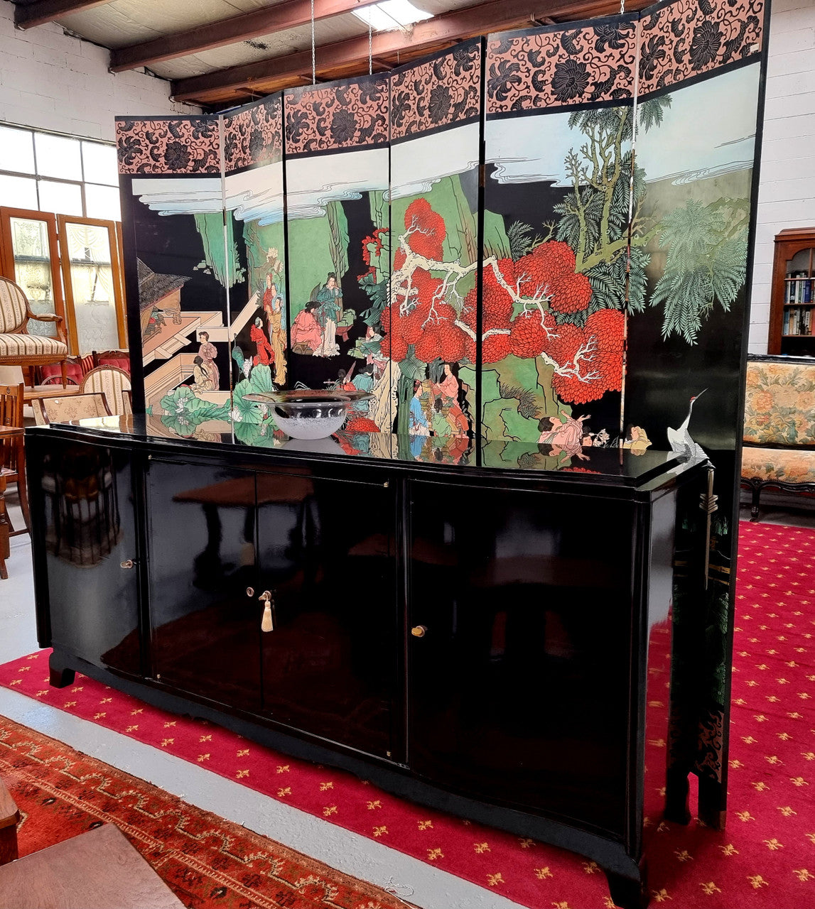 French Art Deco sideboard with a custom black lacquer finish.  Beautiful serpent shaped front with four cupboards with working locks and includes to working keys. It is in original condition.