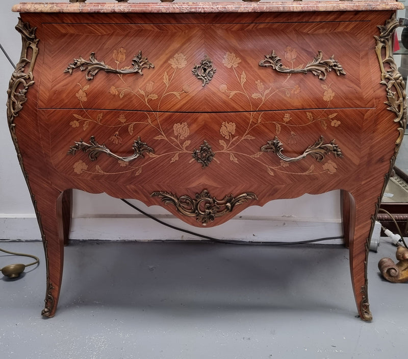 Stunning Louis XV style marquetry inlay marble top two drawer commode. It has decorative ormolu mounts and beautiful marble top. In good original detailed condition.