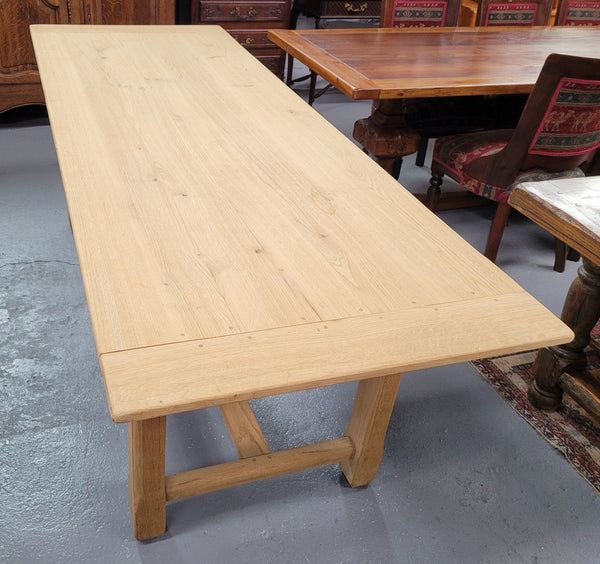 French raw Oak stretcher based refectory table. Features raw wood that could be used as is for a distressed look, or finished and waxed for a more refined look. Sourced from France and in good original condition.