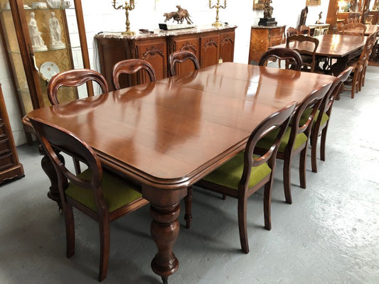 Lovely Victorian Walnut Extension dining table on castors and 8 lovely upholstered dining chairs in good condition.