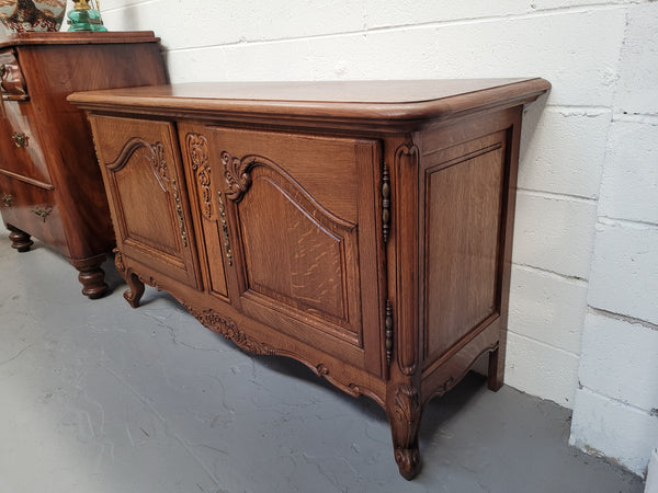 French Oak Louis XV Style two door nicely carved cabinet which would make an ideal TV cabinet. There are two doors for all your storage needs and is a very solid piece. In good original detailed condition.