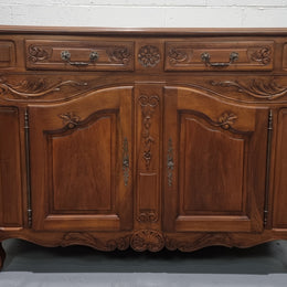 French Walnut two door buffet with parquetry top. It has two drawers and an adjustable shelf. In good original detailed condition and it has been sourced from France.