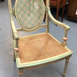 Painted French Louis XVI style cane panel arm chair. Paint is original and it is in very good original condition.