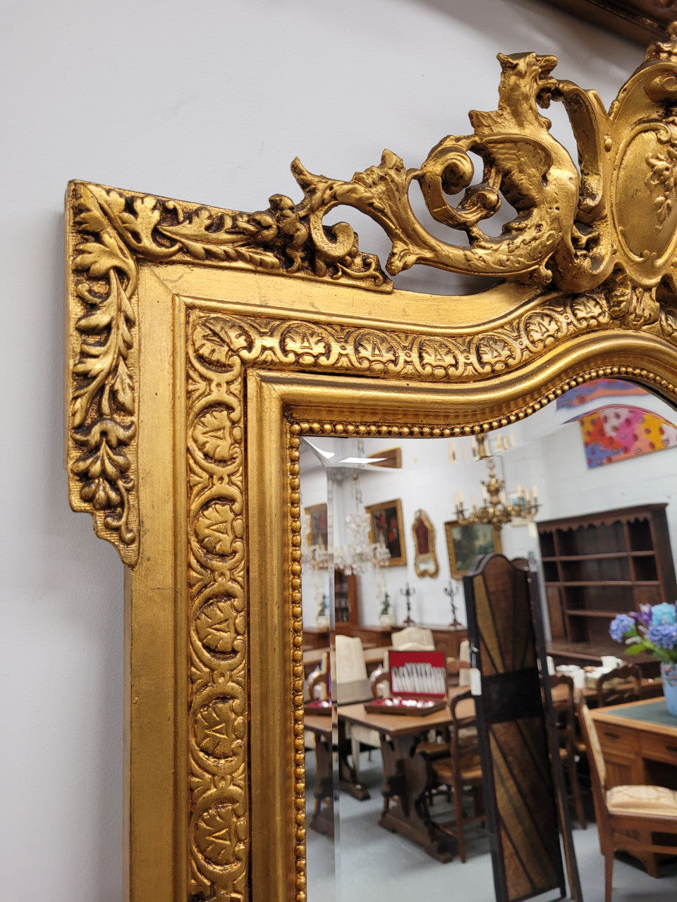 Stunning 19th Century French gilt mantle mirror. Bevelled mirror and amazing hand carved crest. It has been sourced from France and is in good original detailed condition.