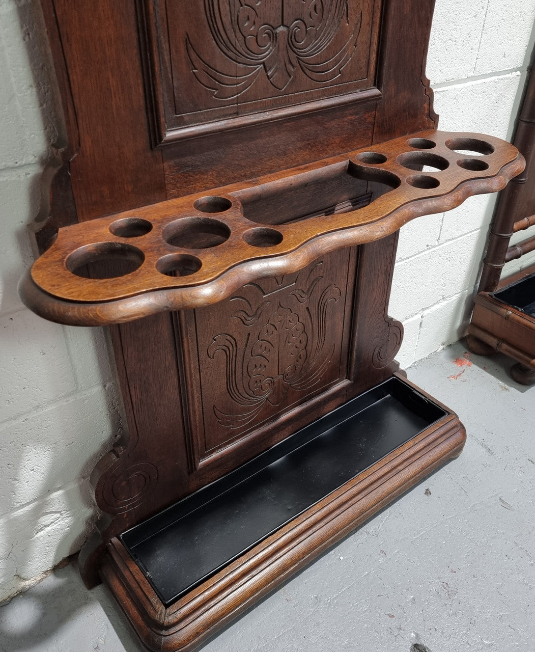 A beautiful Henry II style narrow French Oak hall stand. It has beautiful decorative carvings as well as 8 wooden hooks and storage for umbrellas and walking sticks. In good original detailed condition.