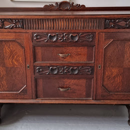 Art Deco Tudor style Oak sideboard with decorative carved detail. Plenty of storage space with two cupboards and four drawers. It has been sourced locally and is in good original detailed condition.