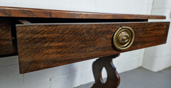 French dark Oak two drawer console table. It has loads of character and is in good original detailed condition.
