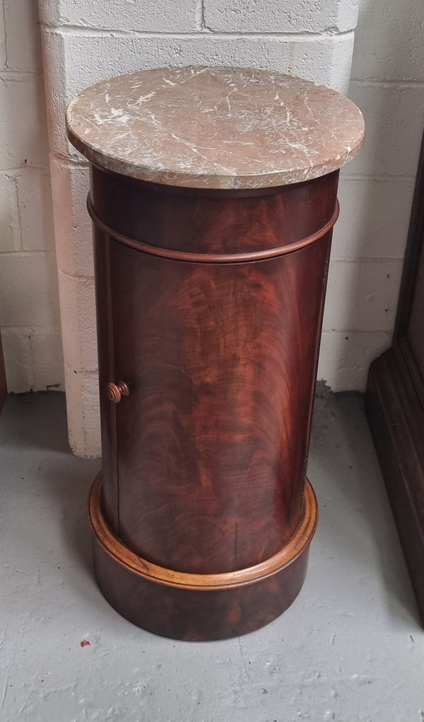 Unusual Empire flame Mahogany cylindrical marble topped bedside/pedestal. Would make an ideal pedestal with added storage inside or could be used as a bedside. Sourced from France and is in good original detailed condition.