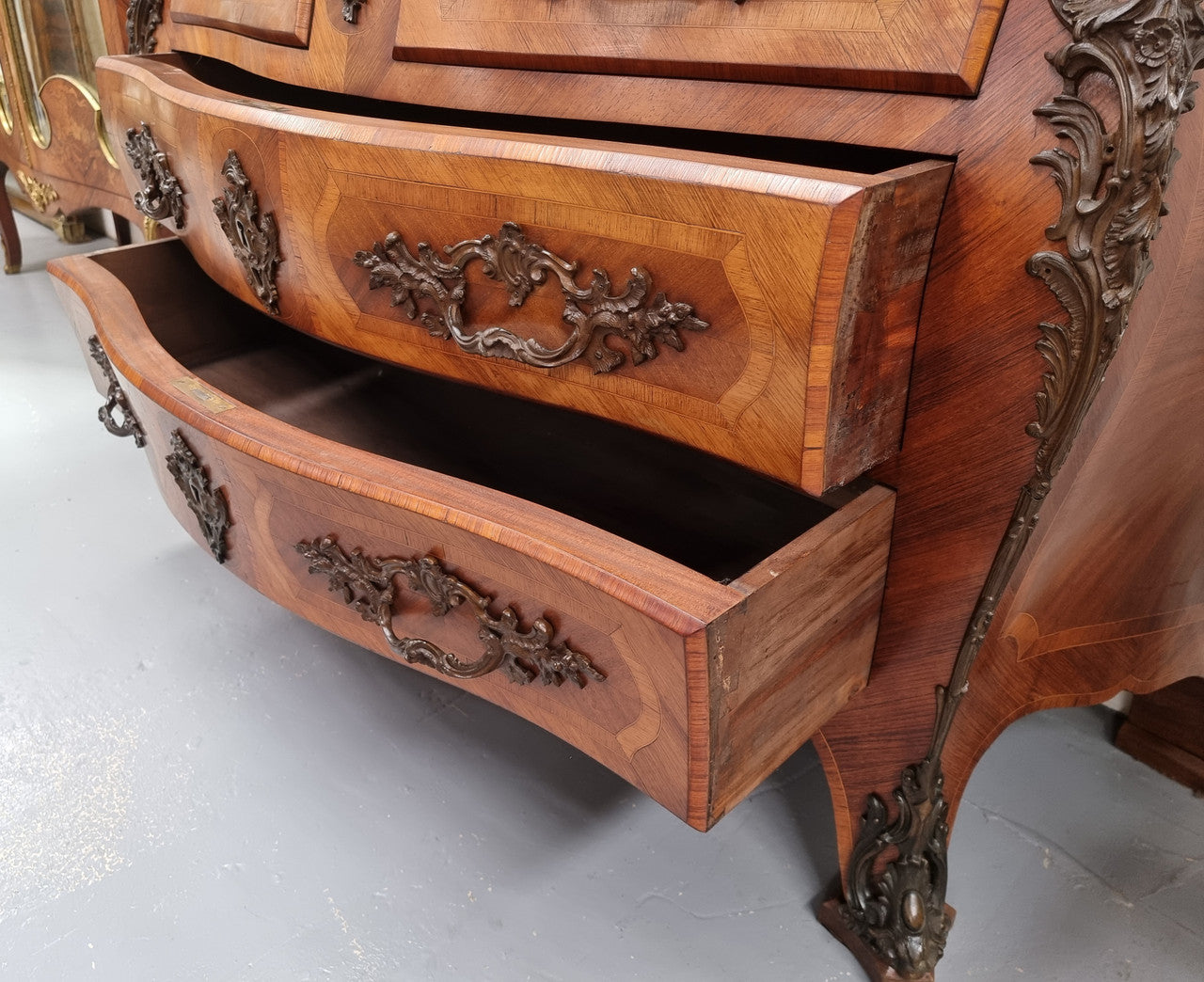 Sensational Grand French Walnut Bombe Commode with beautiful marquetry inlay. It has lovely decorative hardware and an amazing marble top in good original detailed condition.