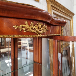 Lovely Vintage French Louis XVth style Vitrine. It has lovely gilt mount details and two glass shelves with room also for storage in good original condition.