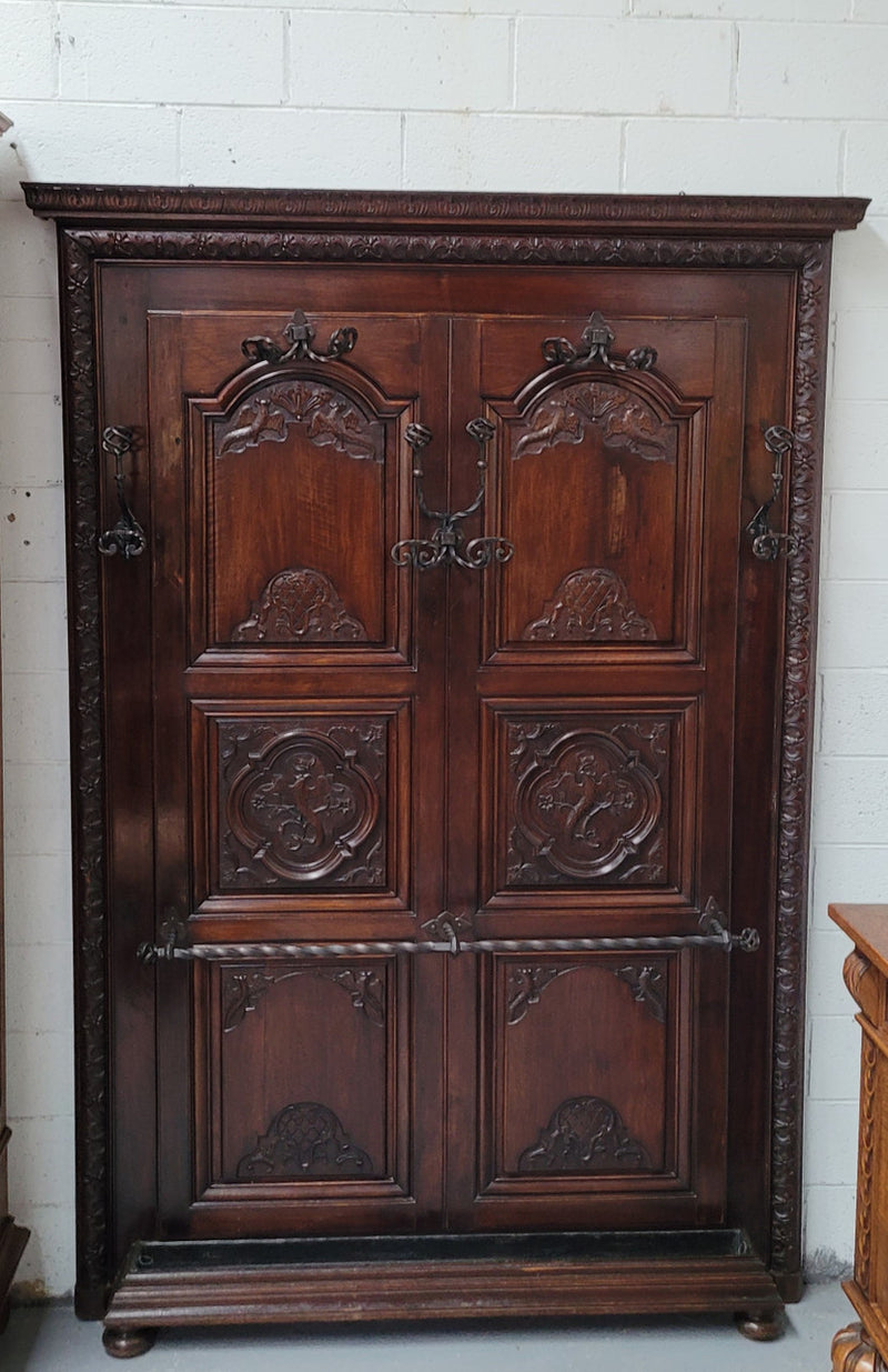 French Henry II 19th century narrow proportioned Walnut hall stand. Full of Character with stunning hand forged wrought iron hooks and interesting carvings. In good original detailed condition.